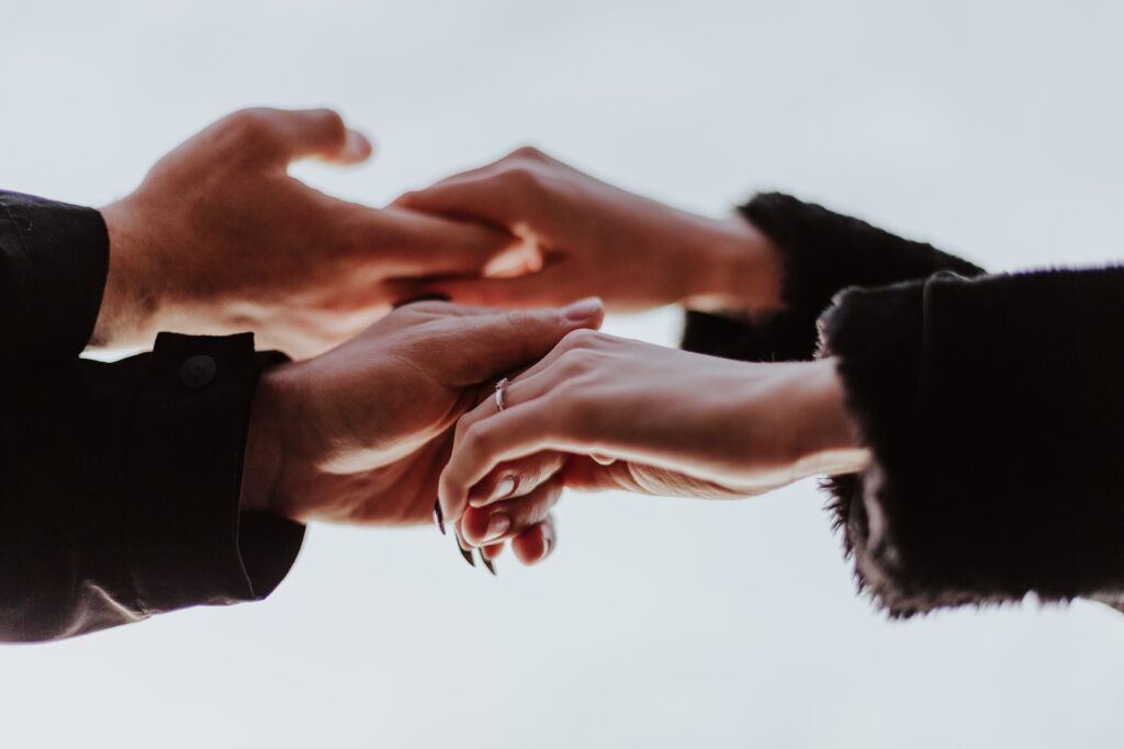 Hands reaching out to each other in support.